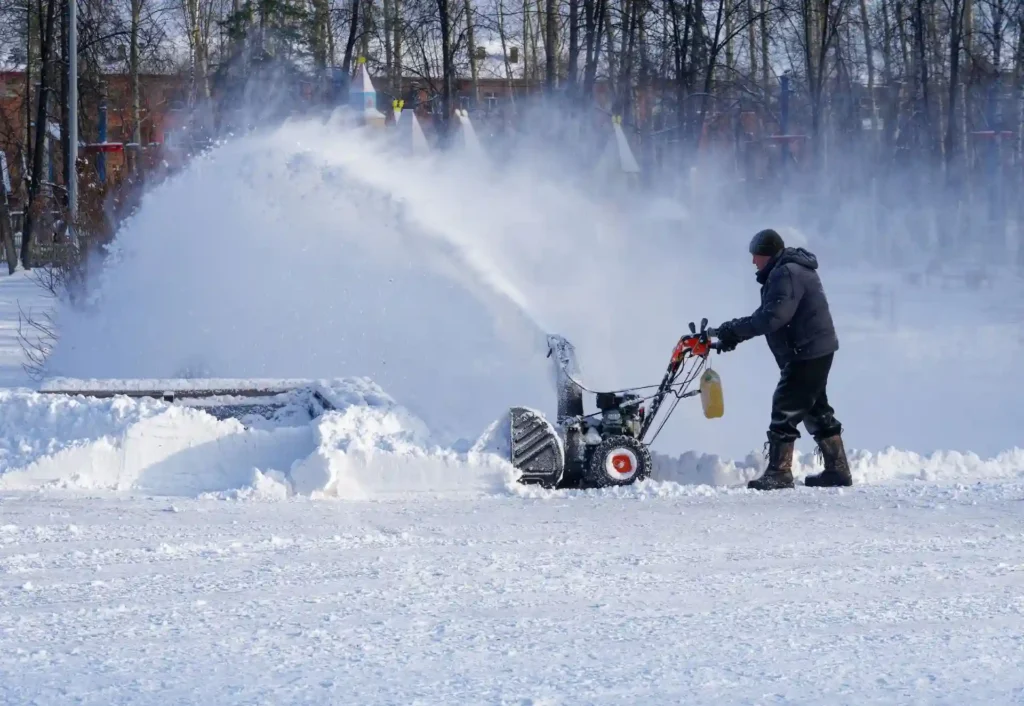 Man removing snow with snow blower