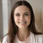 Profile picture of pretty smiling young woman posing indoors